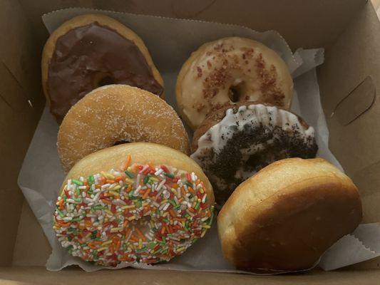 Chocolate glazed, maple bacon, cinnamon sugar, cookies and cream, sprinkles, and Boston cream! Not pictured, the amazing sour cream