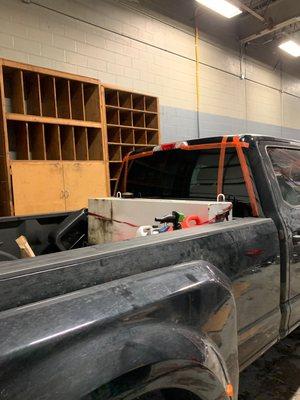 Replacing rear back window on the pick up truck in our shop