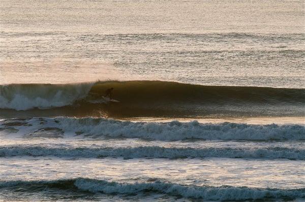 Aleks surfing in front of the shop. Photo by Darren Akana.