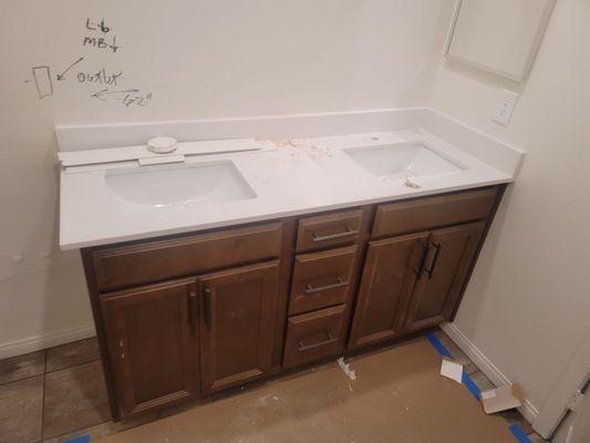 The short Vanity they installed after it being plummed for an extended vanity for months.