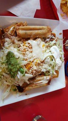 I forget the name: tamale, chips, rice, beans, chicken, beef, toppings, 2 taquitos (1 chicken, 1 steak)