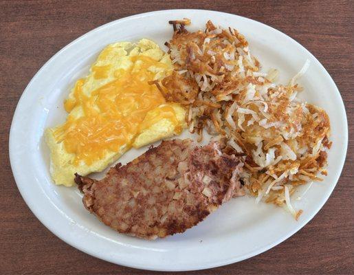 Corn, beef, hash, and eggs breakfast. I asked for cheddar on the scrambled eggs very good.