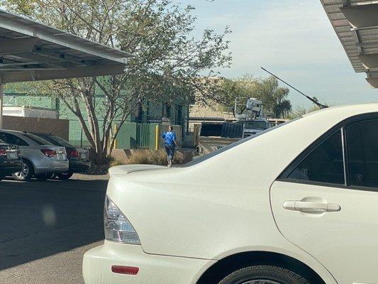 Employee smoking in the front parking lot