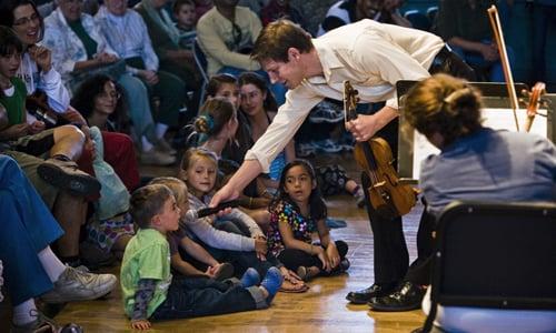 Festival violinist Benjamin Tompkins and young audience member, 2011