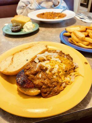 Cajun Dog - Andouille sausage on a french roll topped with chili, onion & cheddar cheese