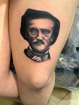 Portrait of Edgar Allen Poe by Mike Case, done on my thigh.