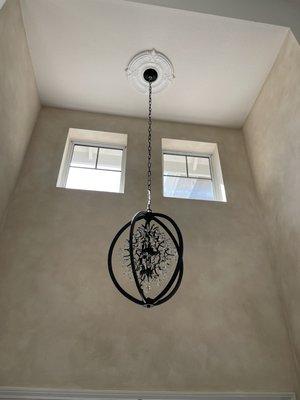 Installed chandelier on high ceiling in customer home above stairwell and in entry.