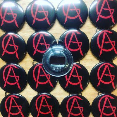 Custom 2.25" key-ring bottle opener buttons for Seattle hard rock band, Atrocity Girl.