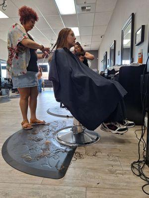 Erika cutting my daughter's hair.