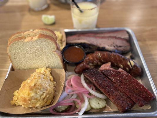 3 meat plate with brisket ribs and jalapeño sausage with corn casserole on the side.