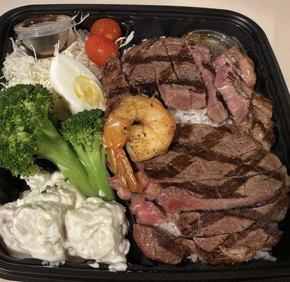 1/2lbs Rib-eye Steak Rice Plate (Medium Rare) includes sides of potato salad, broccoli, cabbage salad with tomatoes, & Spicy Sauce