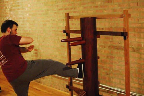 Louis D working on the wooden dummy.