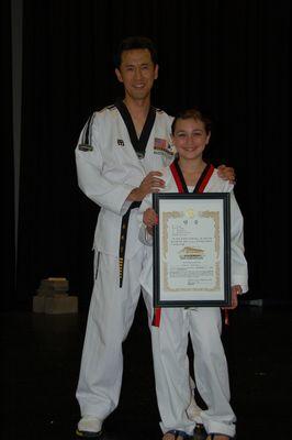 Master Yoo with student receiving first black belt