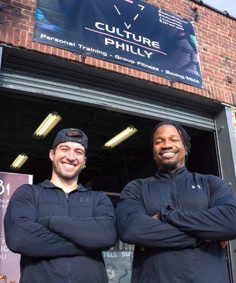 Owners/Trainers, John Pizzigoni and Brandon Johnson, smiling outside of Culture Philly Gym