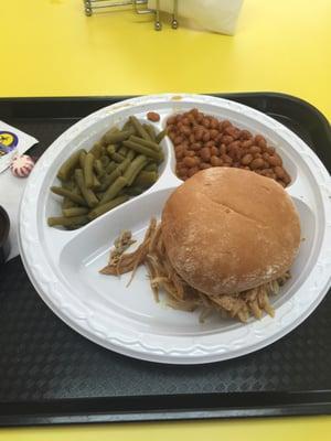 BBQ pulled chicken sandwich with baked & green beans.