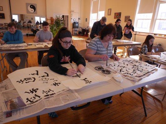 Family calligraphy class at J. R. Roy Martial Arts.