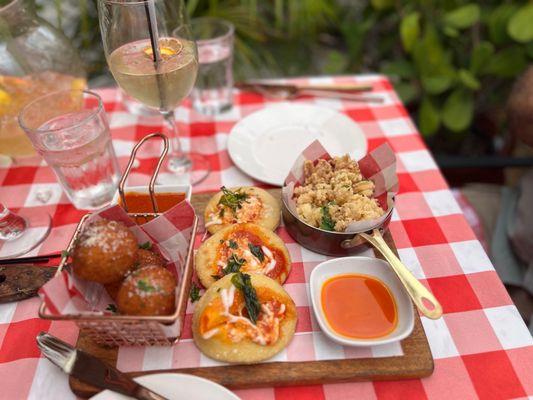 Italy street food appetizer. Risotto balls, calamari and small pizza.