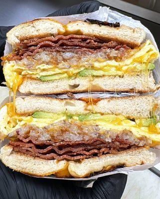 Bacon, egg, and cheese on a jalapeno cheese bagel with added avocado and hashbrowns