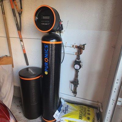 Puronics Water filtration system installed in garage.