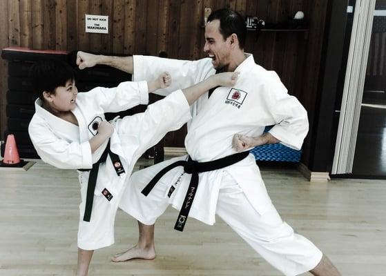 One of our senior members with his son doing a kicking training.