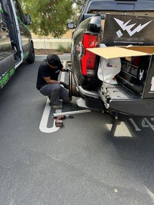 Edgar double checking the fitment of my new rims and lugs on my truck.