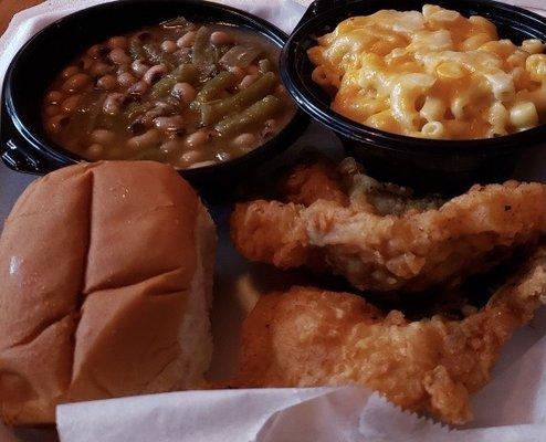 Fried pork chop, field peas and snaps, Mac n cheese, and a roll