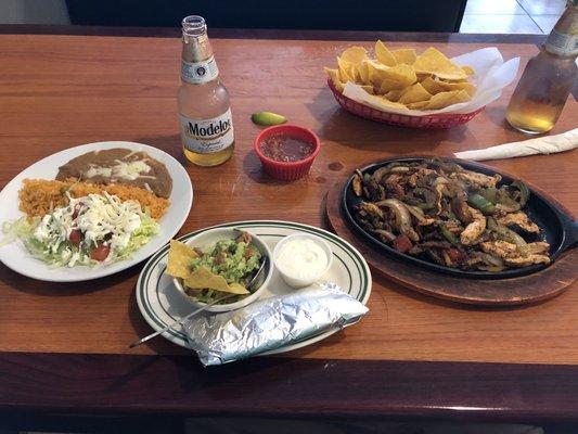 Mix of chicken and steak fajitas with toppings.