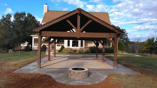 Pavilion assembled and concrete poured. Built fire pit as well.