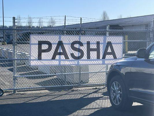 Gate with white "PASHA" sign where you should pull the car to be shipped up to.