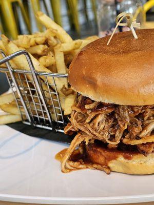 The Big Pig Burger next to the basket of fries.