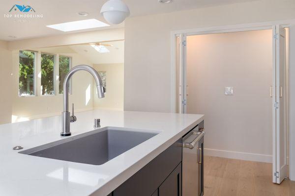 Perfect for entertaining! Top Remodeling & Design created this beautiful kitchen with custom cabinetry and elegant lighting.