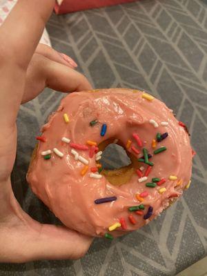 Strawberry frosted donut with sprinkles