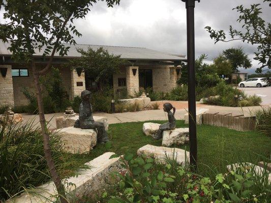 Laura Bush reading to girl outdoor sculpture