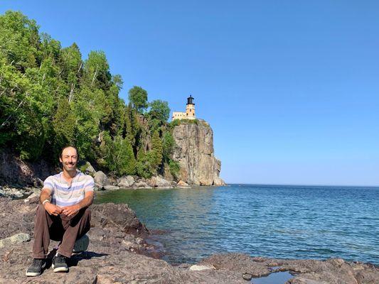 Taking a seat on the rocks enjoying the setting with Split Rock Lighthouse in the background.