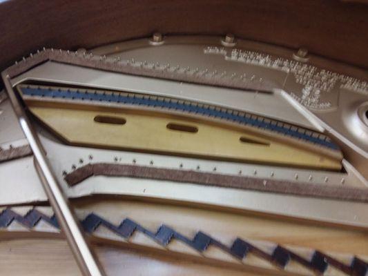 The plate, soundboard and bridges of a Knabe grand piano before restringing.