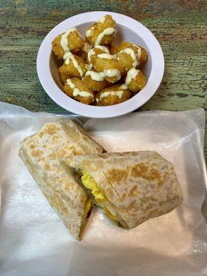 American American Breakfast Burrito and tatie tots with a garlic cilantro aioli sauce