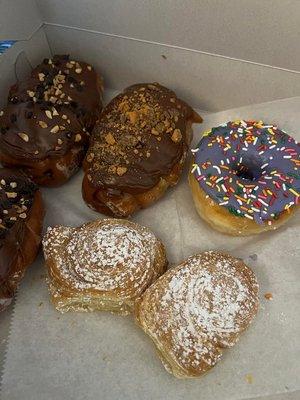 Top left to right: Chocolate peanut butter roll, butterfinger roll, and taro simpsons donut. Bottom: Cronut holes