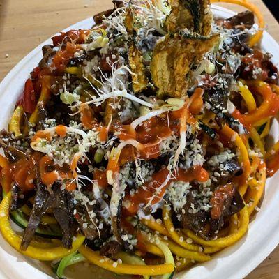 Raw mixed noodles topped with dehydrated eggplant and plantain shredded meat.