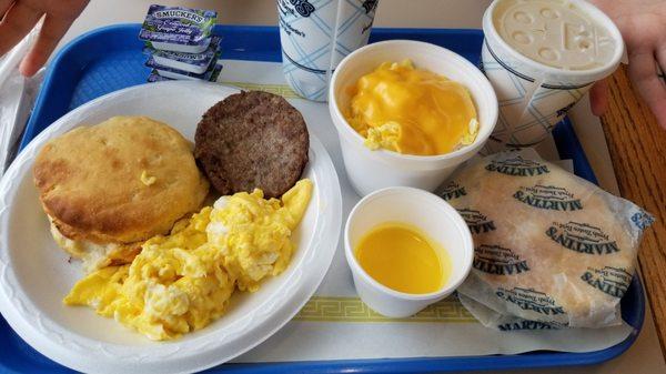 Sausage plate with breakfast mixer bowl. And a cup of butter.