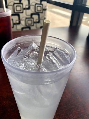 Delicious agua de limón with a paper straw