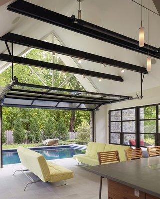 A combo exterior glass garage door, pool and lounge area!