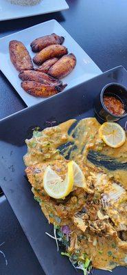 Fried plantain, and whole fish with a side pepper sauce