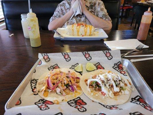 Yum mahi mahi and chicken tacis and my friend has one gigantic burrito.