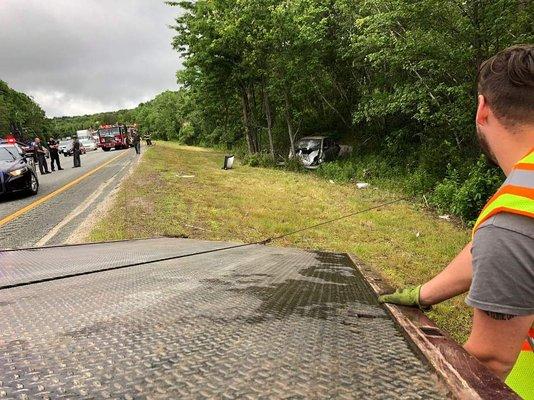 A highway recovery car into some trees