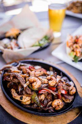 Combo Fajitas served on a sizzling cast iron pan