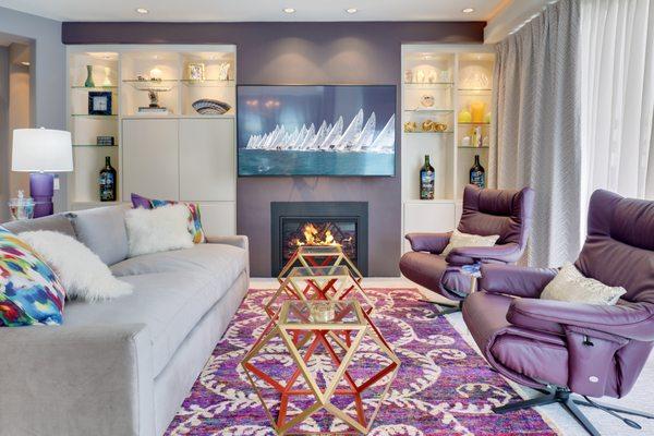 Silk rug, modern swivel recliners, and custom built-ins in Living Room by Ashleigh Underwood Home & Interior Design.