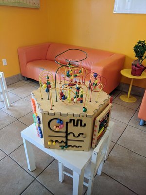 Kid friendly, tiny tables for kids, hip couches and modern chairs for older kids and adults.