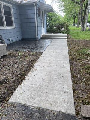 New step, sidewalk front colored, and stamped patio.