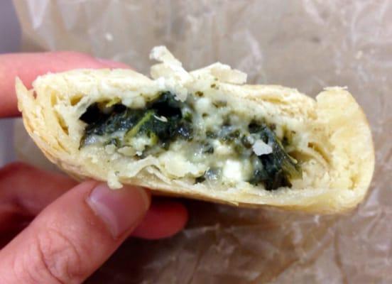 Close-up on the flavorful spinach and feta filling in the flaky and buttery croissant. _ 04/04/2016.