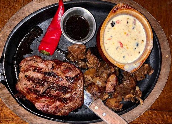 Bone-In Ribeye with skillet potatoes and creamed corn.